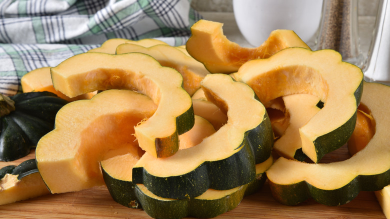 Sliced acorn squash on wooden board