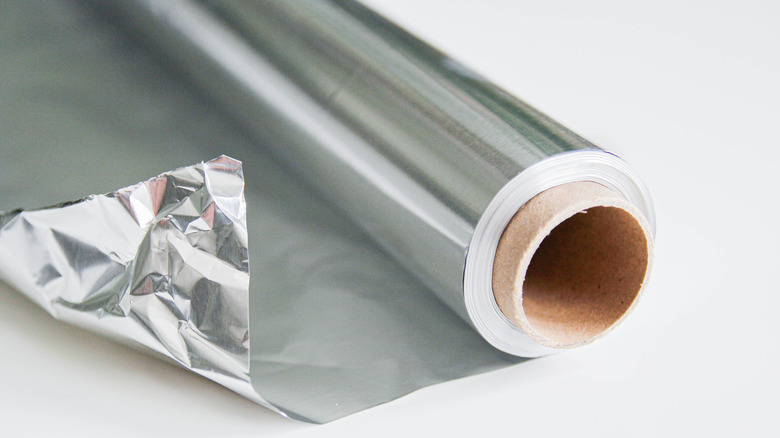 A roll of aluminum foil on a counter