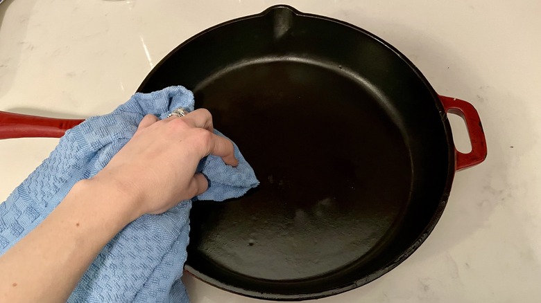 Person wiping cast iron