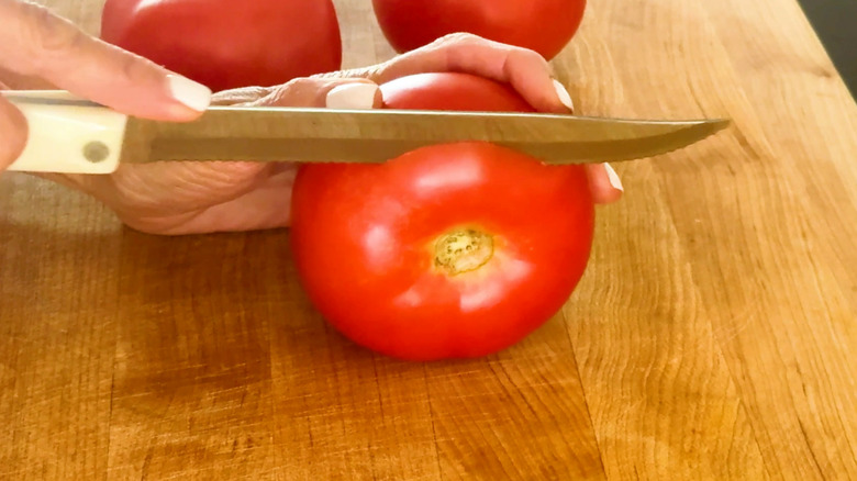 Serrated knife on tomato