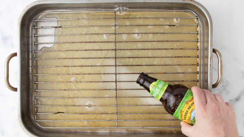 Pouring beer into cooking pan