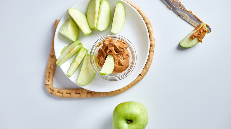 Apple slices on plate peanut butter