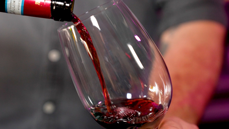 Red wine pouring into glass