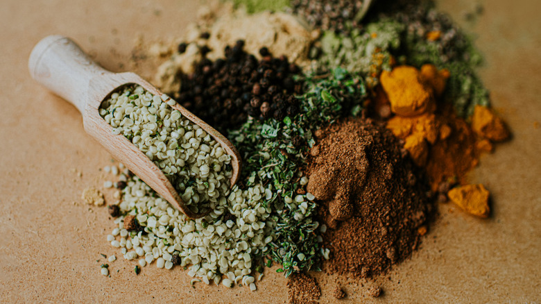 Dried herbs and spices with wooden scoop