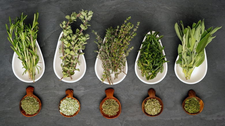 Fresh and dried herbs in bowls