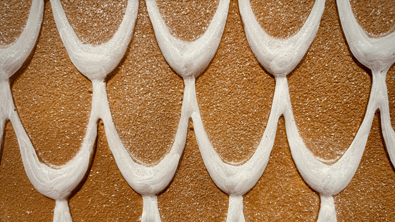 Royal icing piped on gingerbread to give a roof tile pattern