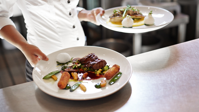 Waiter holding different dishes