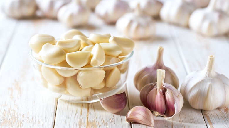 Fresh peeled garlic in a glass bowl