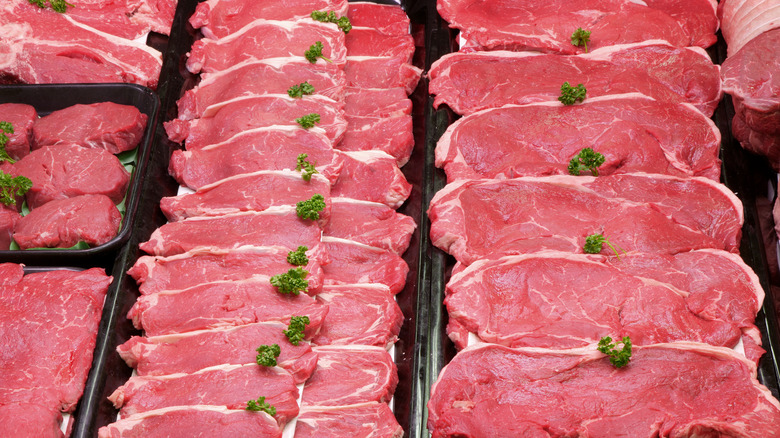 rows of raw thin-cut steaks