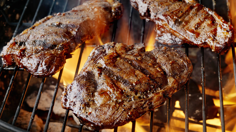 3 steaks on grill