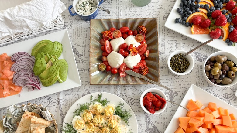 brunch table laid with a variety of cheese and cold foods