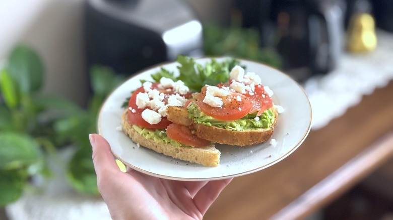 hand holding plate of sliced