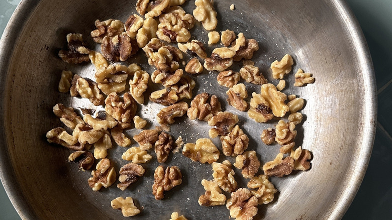 Raw walnuts in metal skillet