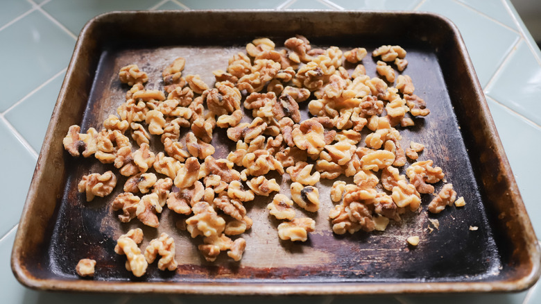 Raw walnuts scattered on tray