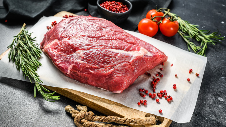 Raw brisket on cutting board