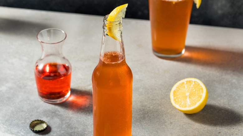 Spaghett drink next to lemon wedge and glass of Aperol