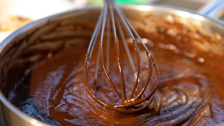 Chocolate cake mix in a bowl with a whisk