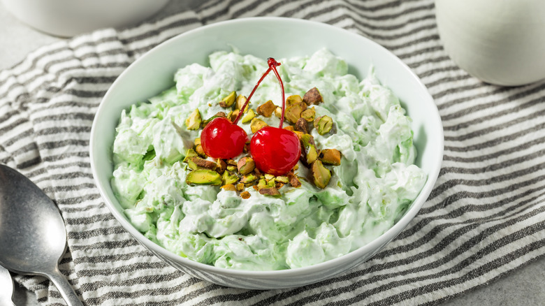 Bowl of Watergate salad with cherries and chopped pistachio