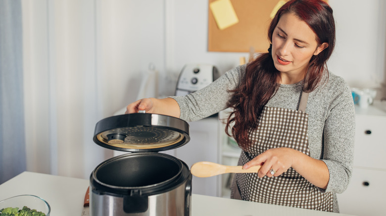 woman using a slow cooker