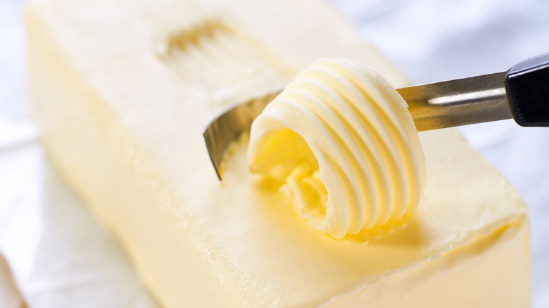 bright butter is sliced into a spiral from the top.