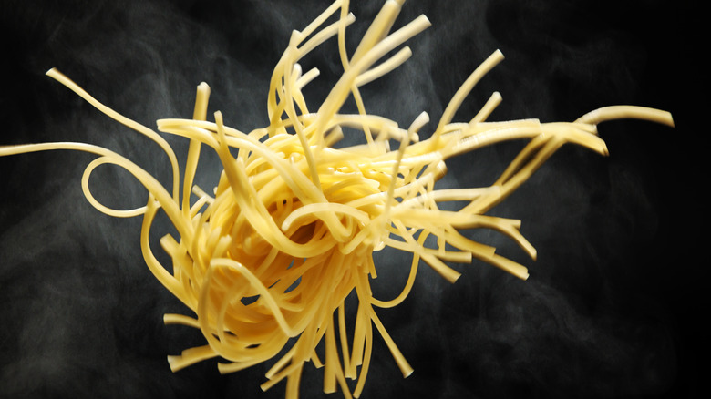 fresh noodles against black background