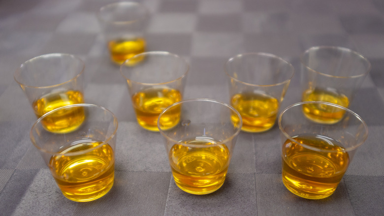 Whiskey solution in small plastic cups to trap fruit flies
