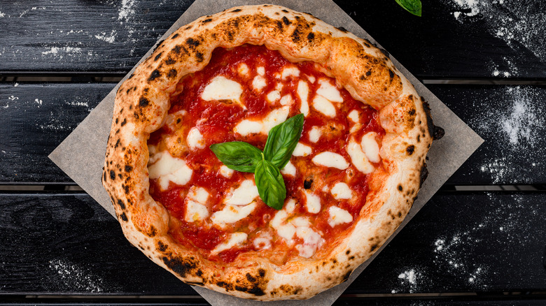 Margherita pizza on dark background