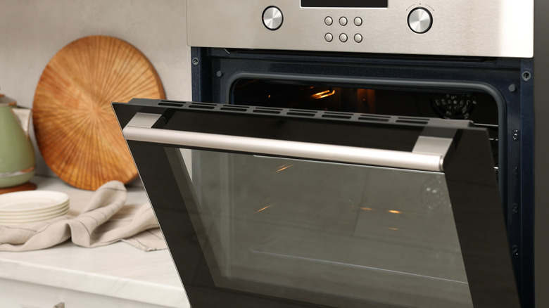 An open built-in oven in a kitchen.