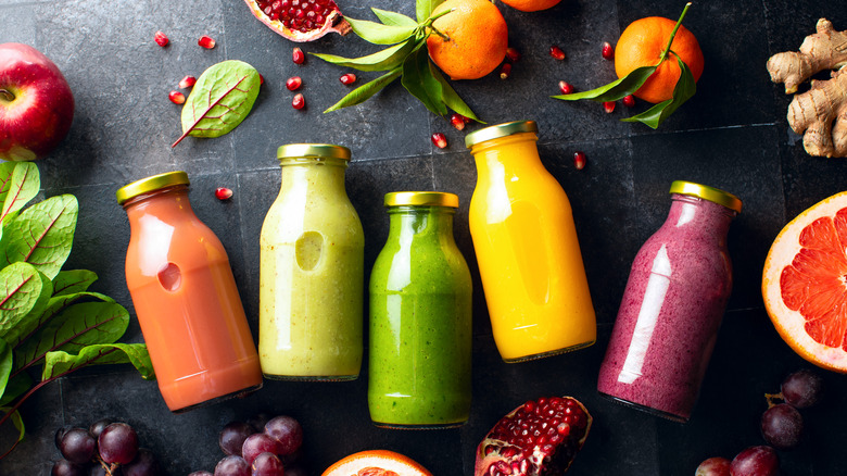 Various colorful smoothies in bottles