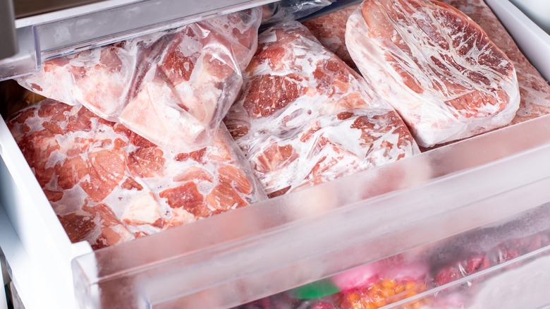 Frozen meats and vegetables in freezer drawers