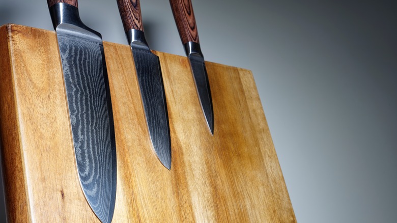 Sharp knives on cutting board