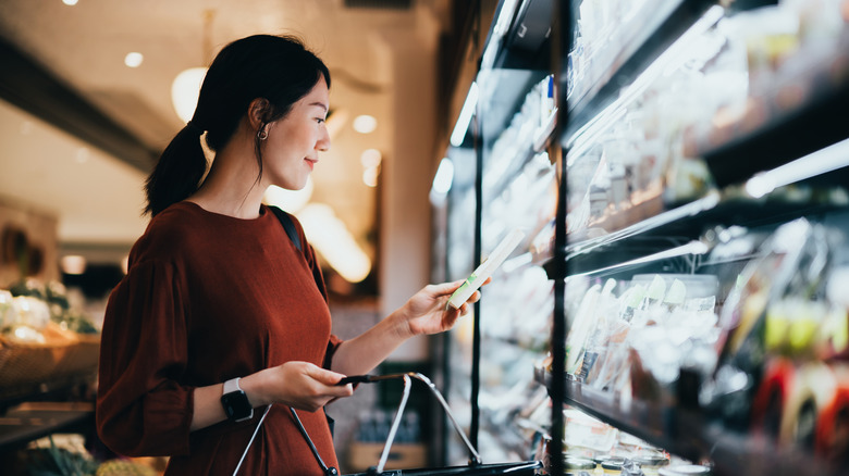 Woman shopping the deli aisle