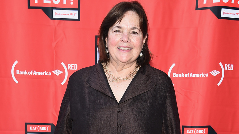 Ina Garten smiling on red background