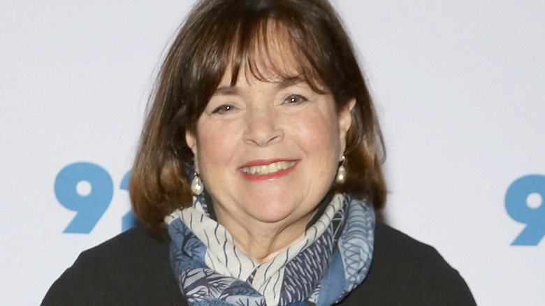 Ina Garten smiling with blue printed scarf and black coat