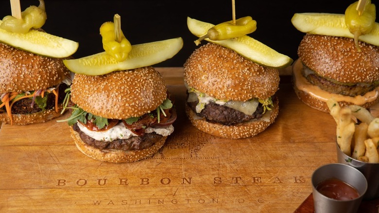 Bourbon Steak burgers on wood table