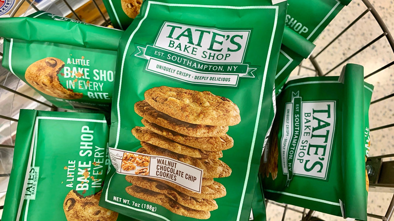 Basket full of green bags of Tate's Bake Shop cookies