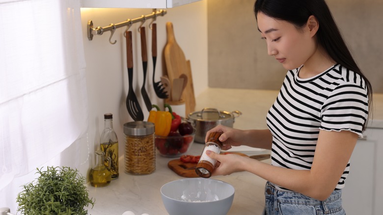 Woman salting food