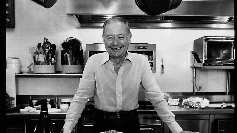 Craig Claiborne in a kitchen in black and white