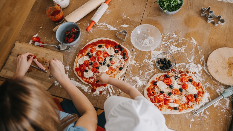 making pizza on wooden board