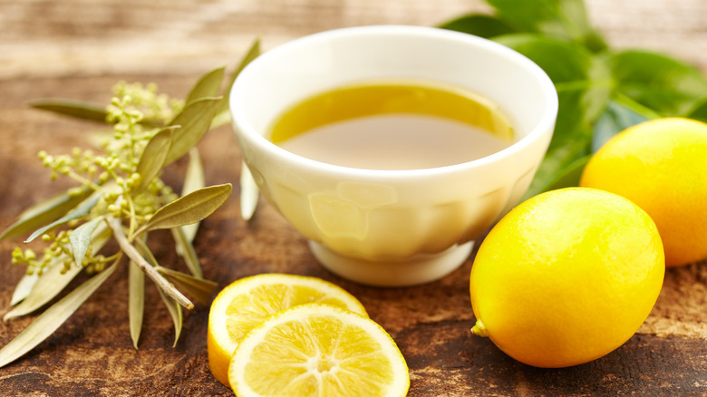 Olive oil in bowl, lemons