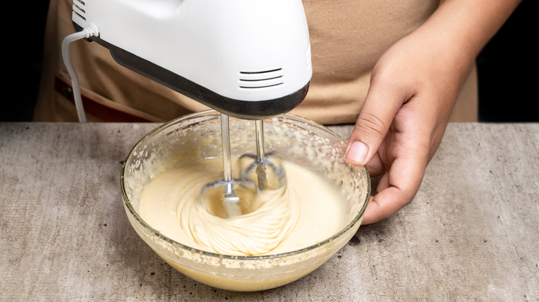 person mixing pancake or waffle batter