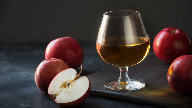 brandy in snifter and red apples