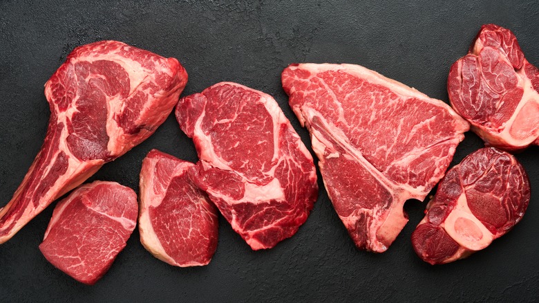 Various beef steaks on slate