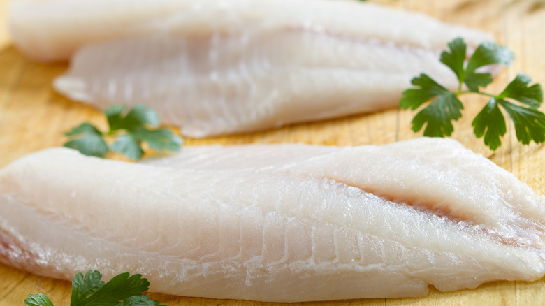 White fish filets on cutting board