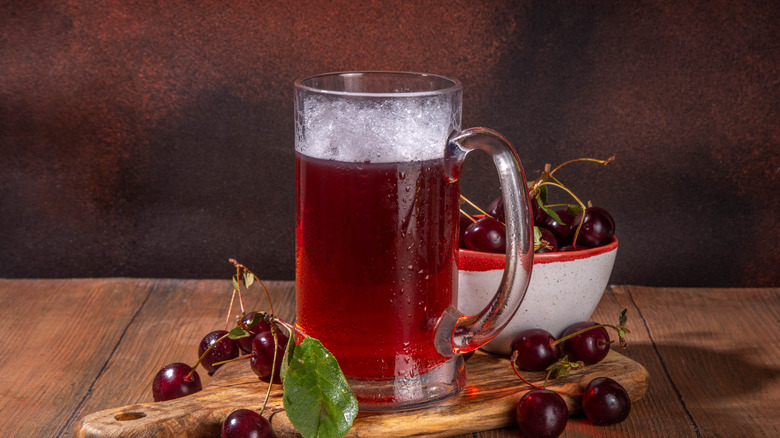 Cherry hard cider in glass with cherries