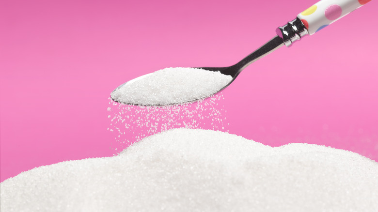 mountain of granulated sugar with spoon