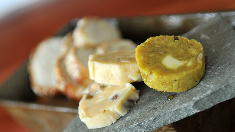 Compound butter discs on a slab of stone