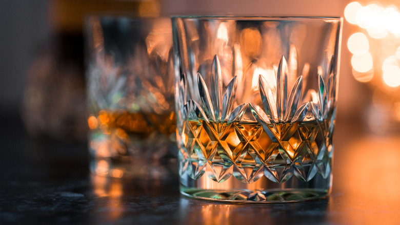 Bourbon in an etched glass illuminated by background light