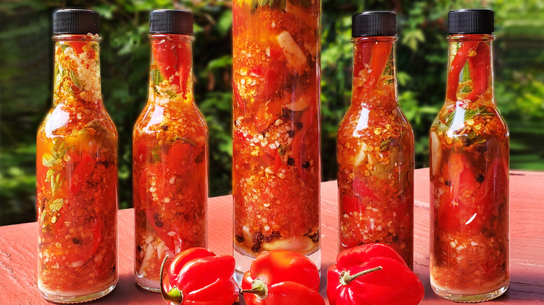 Bottles of hot sauce made with peppers and herbs