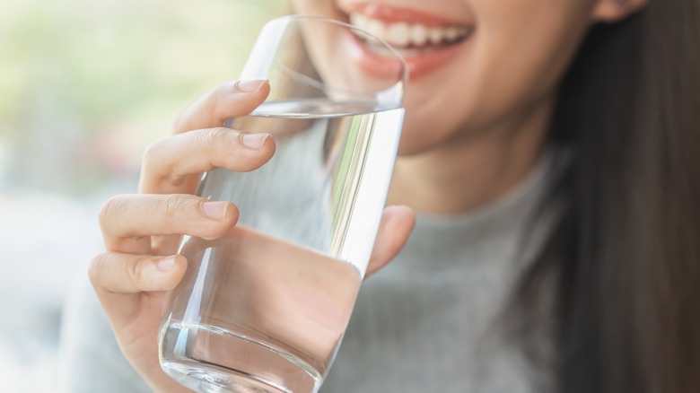 Woman sipping glass of water